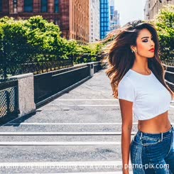 a woman with long hair is posing for a picture . 