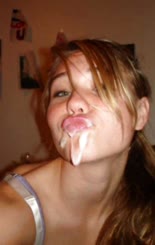  A woman with her tongue in her mouth taking a picture of herself