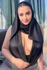 a woman wearing a scarf and a top with a large breast